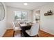 Inviting dining area with a modern table setting, hardwood floors, and a convenient wine rack at 7521 S Race St, Centennial, CO 80122