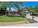 Charming two-story home with a well-maintained lawn, mature trees and a basketball hoop above the garage at 7521 S Race St, Centennial, CO 80122