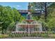 Beautiful tiered fountain with cascading water features, surrounded by lush greenery and landscaping at 7521 S Race St, Centennial, CO 80122
