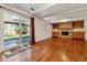 Spacious living room boasts hard wood floors, fireplace with built-ins, and access to fenced yard at 7521 S Race St, Centennial, CO 80122