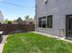 Small backyard with a well-maintained lawn and wood fence for privacy at 1568 Wolff St, Denver, CO 80204