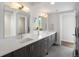 Bright bathroom with double vanity, sleek countertops, and a view into a modern tiled shower at 1568 Wolff St, Denver, CO 80204