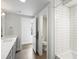 Bright bathroom featuring a tub with tiled walls and a modern vanity at 1568 Wolff St, Denver, CO 80204