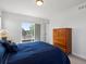 Bedroom features a large window with a great view, and an ample wooden dresser at 1568 Wolff St, Denver, CO 80204