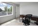 Bedroom with a large window and a view to the backyard, featuring a dark wood desk at 1568 Wolff St, Denver, CO 80204