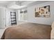 Well-lit bedroom with large window offering neighborhood views, art, and carpeted floors at 1568 Wolff St, Denver, CO 80204