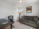 Bedroom with desk and sofa, featuring a closet and window at 1568 Wolff St, Denver, CO 80204