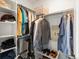 Well-organized closet with shelving, hanging rods, and storage for clothes and shoes at 1568 Wolff St, Denver, CO 80204