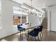 Stylish dining area with contemporary lighting fixture and modern chairs at 1568 Wolff St, Denver, CO 80204