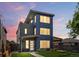 Modern three-story home with a roof top deck, large windows, and attractive landscaping at 1568 Wolff St, Denver, CO 80204