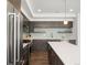 A sleek modern kitchen is fitted with stainless steel appliances and wooden floors at 1568 Wolff St, Denver, CO 80204