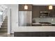 Kitchen with stainless steel appliances, quartz countertop island, and adjacent stairs at 1568 Wolff St, Denver, CO 80204