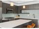 Well-equipped kitchen featuring a large island, stainless appliances, and sleek cabinetry at 1568 Wolff St, Denver, CO 80204