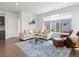 Inviting living room featuring a comfortable sectional sofa, stylish rug, and plenty of natural light at 1568 Wolff St, Denver, CO 80204