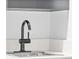 Modern bar sink with black faucet and white countertop at 1900 E Girard Pl # 505, Englewood, CO 80113