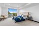 Main bedroom features a plush bed and sliding glass doors with treetop views at 1900 E Girard Pl # 505, Englewood, CO 80113