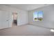 Bright carpeted bedroom offering a large window and ensuite bathroom, offering a private retreat at 3324 N Haleyville Ct, Aurora, CO 80019