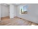 Sunlit bedroom featuring a large window with views of the neighborhood and a bright, airy ambiance at 3324 N Haleyville Ct, Aurora, CO 80019