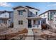 Inviting two-story home featuring stone accents, a covered porch, and professional landscaping at 3324 N Haleyville Ct, Aurora, CO 80019