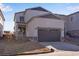 Front exterior featuring a two-car garage, a covered porch, and a well-maintained yard at 3324 N Haleyville Ct, Aurora, CO 80019