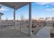 Inviting covered front porch with white railings and views of the neighborhood at 3324 N Haleyville Ct, Aurora, CO 80019
