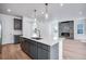 Contemporary kitchen island features stainless dishwasher, gray cabinets, sink, and stylish faucet at 3324 N Haleyville Ct, Aurora, CO 80019
