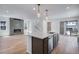 Spacious kitchen with island, stainless dishwasher, stylish faucet, and view of fireplace at 3324 N Haleyville Ct, Aurora, CO 80019