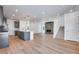 Open-concept living space featuring a modern kitchen with an island, stainless appliances, and a cozy fireplace at 3324 N Haleyville Ct, Aurora, CO 80019