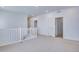 Loft with white banister, neutral carpet, and three access doors at 3324 N Haleyville Ct, Aurora, CO 80019