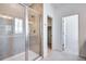 This bathroom boasts a glass shower with decorative tile and a view of a closet at 3324 N Haleyville Ct, Aurora, CO 80019