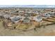 Expansive aerial view of a community highlighting the backyard of a home and its surrounding landscaping at 24525 E Wagon Trail Ave, Aurora, CO 80016