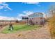 A backyard featuring a play structure, stairs to the deck, and a well-maintained grassy area at 24525 E Wagon Trail Ave, Aurora, CO 80016