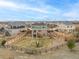 Aerial view of a fenced backyard with a well-kept lawn, swing set, and tiered landscaping at 24525 E Wagon Trail Ave, Aurora, CO 80016