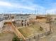 An aerial view of a private backyard with a playground, a green lawn, and a wooden fence at 24525 E Wagon Trail Ave, Aurora, CO 80016