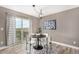 Cozy dining area with modern chandelier, stylish rug, and sliding glass door to outdoor deck at 24525 E Wagon Trail Ave, Aurora, CO 80016