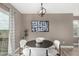Chic dining area featuring a modern light fixture, contemporary artwork, and access to the outdoor deck at 24525 E Wagon Trail Ave, Aurora, CO 80016