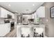 Bright kitchen with white cabinets, granite countertops, stainless steel appliances, and breakfast bar seating at 24525 E Wagon Trail Ave, Aurora, CO 80016