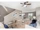 Bright living room open to dining area with modern furnishings and light wood-look floors at 24525 E Wagon Trail Ave, Aurora, CO 80016