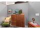 Bedroom with a green chair, wooden dresser and TV at 2500 Walnut St # 106, Denver, CO 80205