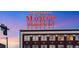 Close-up of the building with Benjamin Moore sign illuminated at dusk, highlighting its architectural details at 2500 Walnut St # 106, Denver, CO 80205