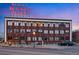 Exterior view of a brick building with 'Benjamin Moore Paints' on top at twilight at 2500 Walnut St # 106, Denver, CO 80205