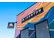 Building exterior featuring Burton logo, bright graffiti-style art, and modern window details at 2500 Walnut St # 106, Denver, CO 80205
