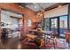 Dining room with brick wall and modern light fixture adjacent to a large outdoor patio at 2500 Walnut St # 106, Denver, CO 80205