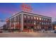 Classic brick building featuring a large sign and cityscape at dusk at 2500 Walnut St # 106, Denver, CO 80205