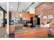 Well-lit kitchen showcasing granite countertops, wood cabinets, a stainless steel refrigerator, and modern fixtures at 2500 Walnut St # 106, Denver, CO 80205