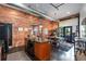 Spacious kitchen and dining area featuring exposed brick, modern appliances, and an industrial-chic aesthetic at 2500 Walnut St # 106, Denver, CO 80205