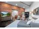 Open concept living room with exposed brick walls, neutral color palette, and industrial-chic accents at 2500 Walnut St # 106, Denver, CO 80205