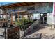 Restaurant exterior with outdoor seating, greenery, and modern industrial design elements at 2500 Walnut St # 106, Denver, CO 80205
