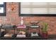 Stylish shelving featuring decorative objects, books, and a plant against an exposed brick wall at 2500 Walnut St # 106, Denver, CO 80205
