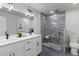 A bathroom with a double vanity and a tiled walk-in shower at 11725 Tomahawk Trl, Conifer, CO 80433